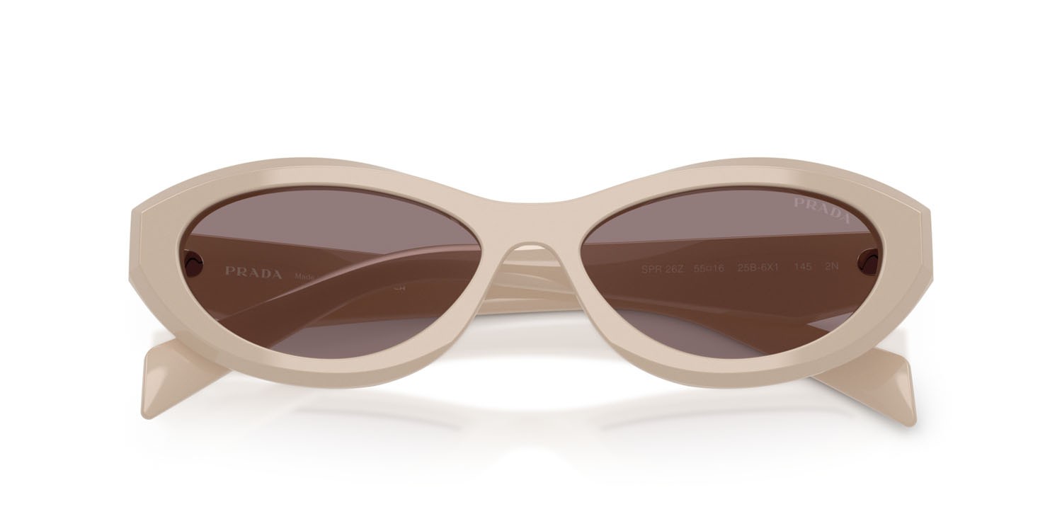 Occhiali da sole Prada PR 26ZS (25B6X1) colore rosa pastello forma irregolare lenti violetto scuro