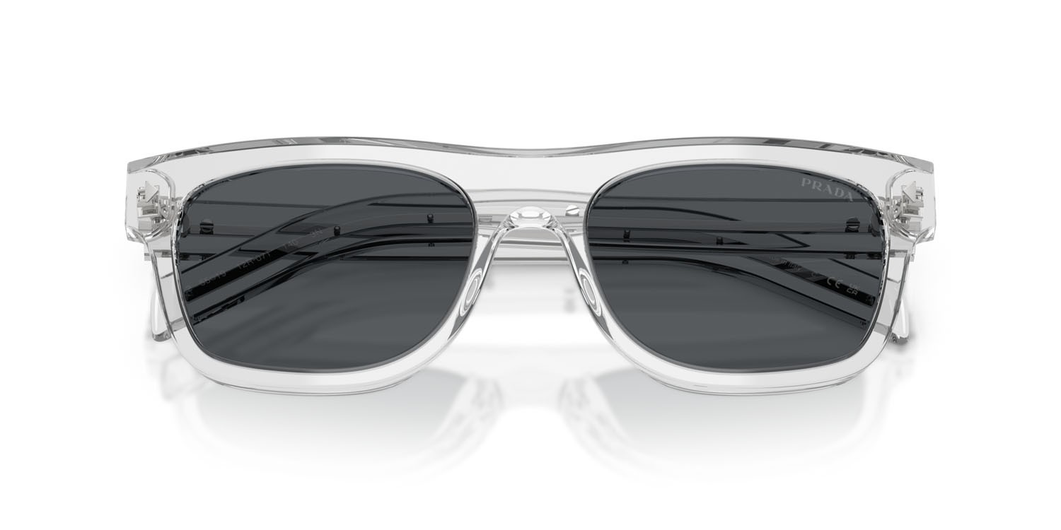 Occhiali da sole Prada PR B12S (12R07T) colore grigio trasparente forma quadrato lenti blu scuro