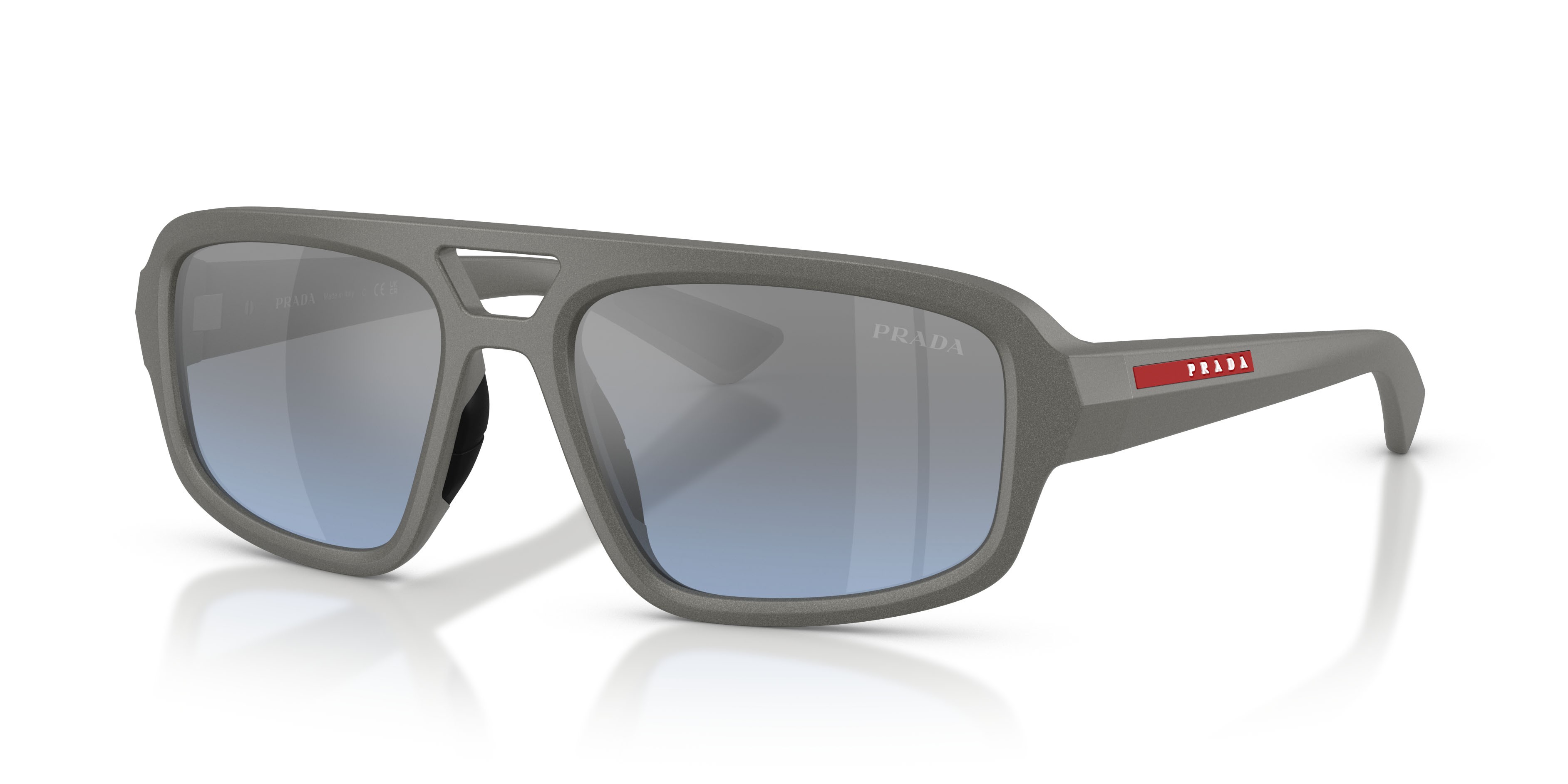 Occhiali da sole Prada Linea Rossa PS B11SU (16X11A) colore grigio metallizzato forma irregolare lenti celeste sfumato argento a specchio