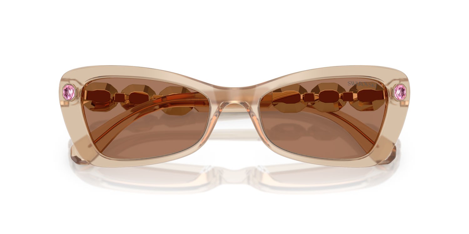 Occhiali da sole Swarovski SK 6033 (106673) colore beige perlaceo forma irregolare lenti marrone