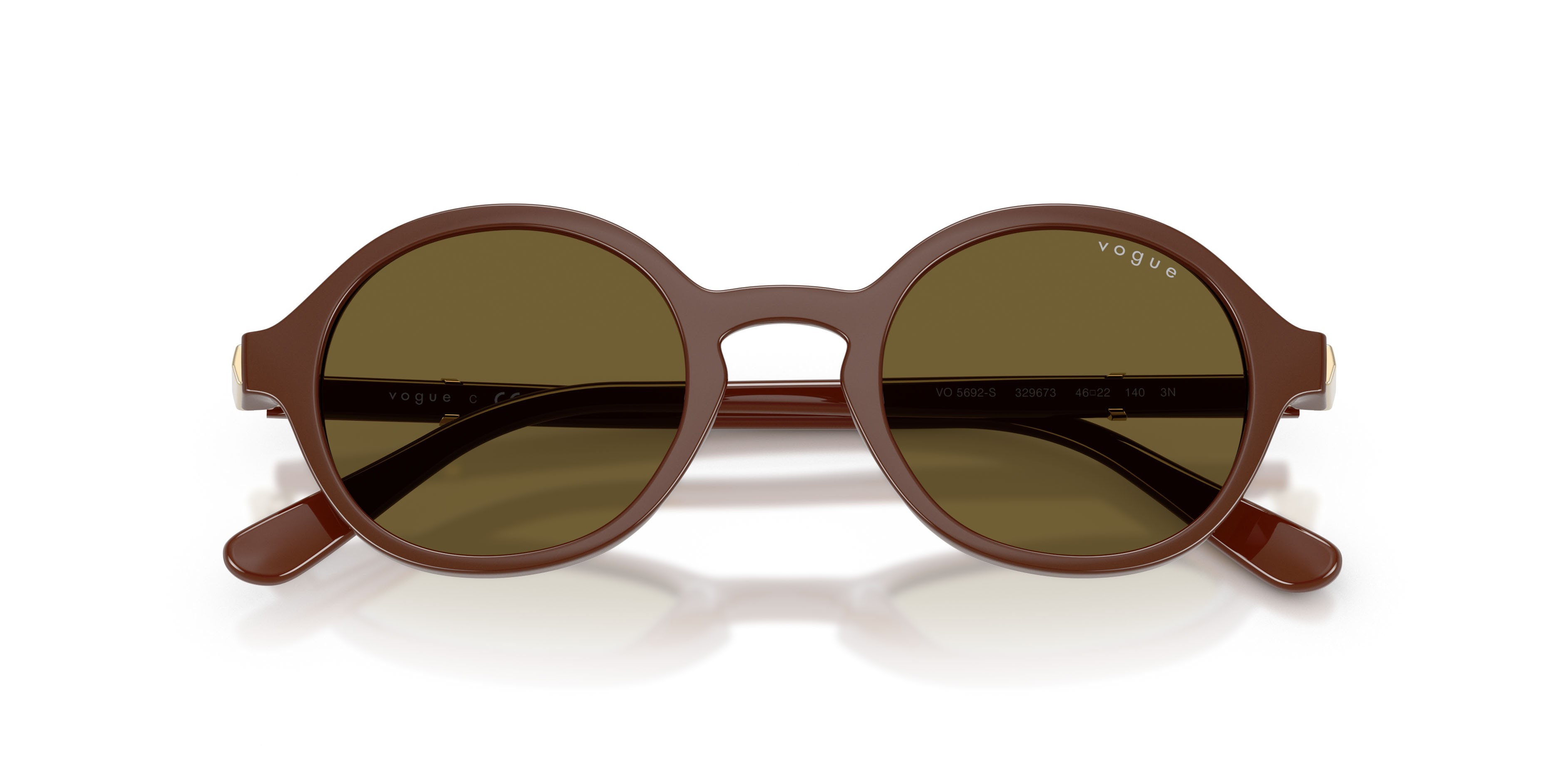 Occhiali da sole Vogue VO 5692S (329673) colore marrone pieno forma rotondo lenti marrone scuro