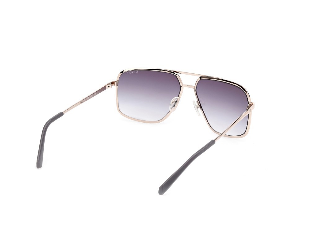 Occhiali da sole Guess GU00167 (20B) colore grigio opaco - oro pallido lucido forma navigator lenti fumo grad.