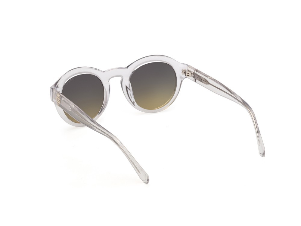 Occhiali da sole Guess GU00205 (26W) colore cristallo / giallo chiaro lucido forma rotondo lenti blu sfumato