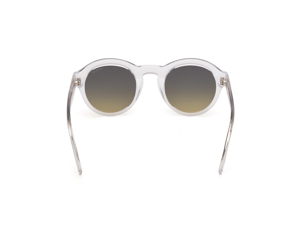 Occhiali da sole Guess GU00205 (26W) colore cristallo / giallo chiaro lucido forma rotondo lenti blu sfumato