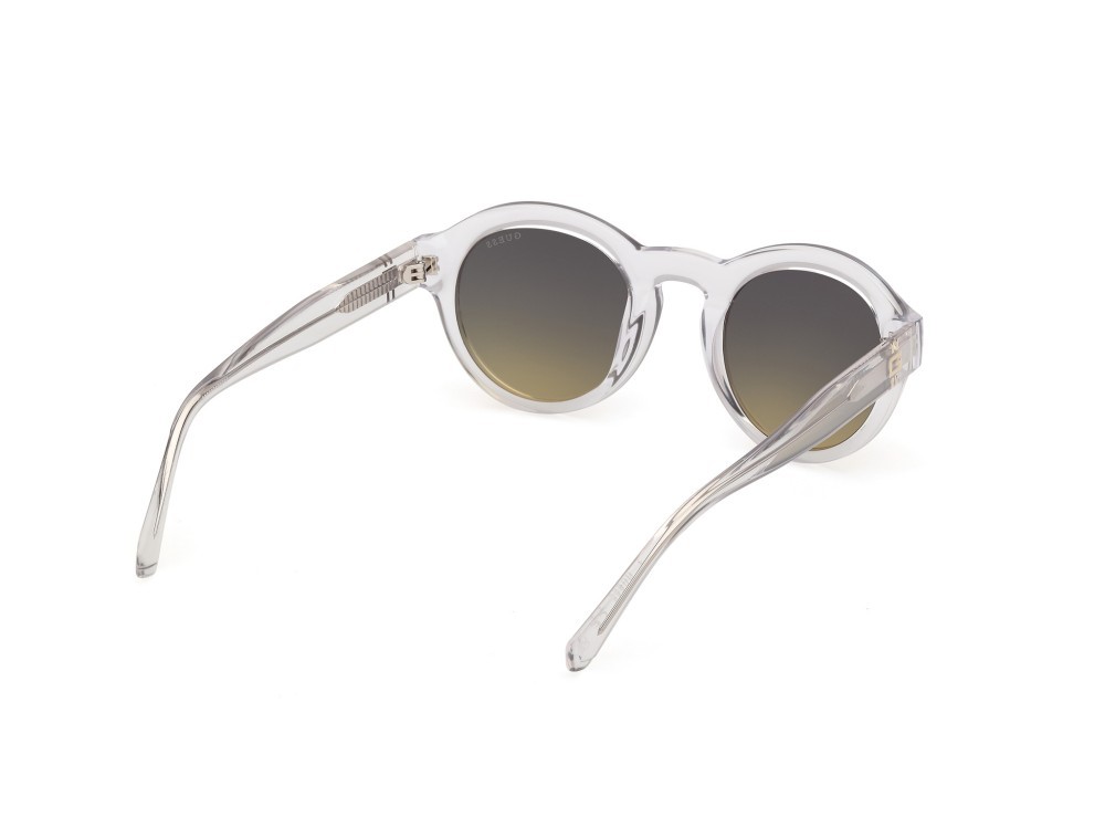 Occhiali da sole Guess GU00205 (26W) colore cristallo / giallo chiaro lucido forma rotondo lenti blu sfumato