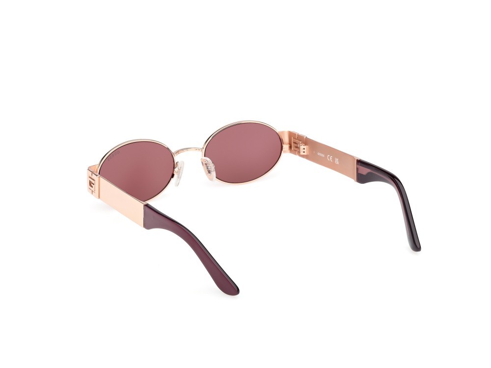 Occhiali da sole Guess GU00262 (28Y) colore oro rosé lucido forma ovale lenti viola