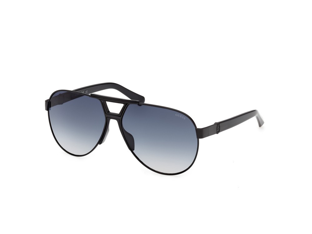 Occhiali da sole Guess GU00304 (01W) colore nero opaco / nero lucido forma aviator lenti blu sfumato