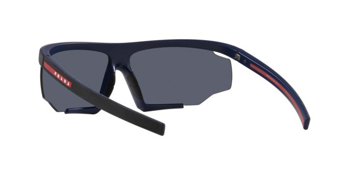 Occhiali da sole Prada Linea Rossa PS 07YS (13K05U) colore nero/rosso effetto gommato forma irregolare lenti blu specchiato