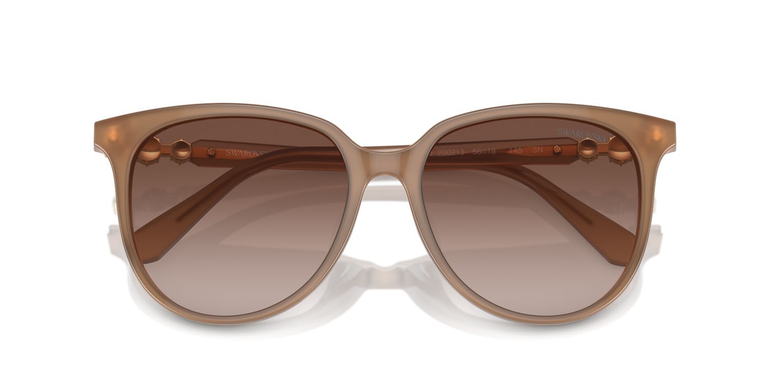Sunglasses Swarovski SK 6023D (200213) color beige opalino shape irregular lenses marrone sfumato